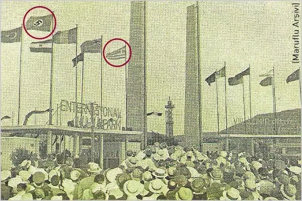 İşte Yeni Asır’da ilk kez yayınlanan bir belge fotoğraf. İzmir Fuarı’nın 1936 yılındaki açılış töreninde Nazi Almanyası ve Yunanistan Krallığı bayraklarının yanı sıra o dönem tek partili rejimin temsilcisi olan CHP bayrağı dalgalanıyordu.